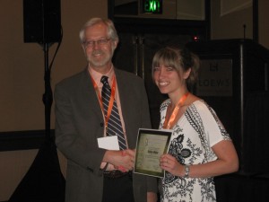 Kaitlyn Maier receives her award from Chip Vorhees, President