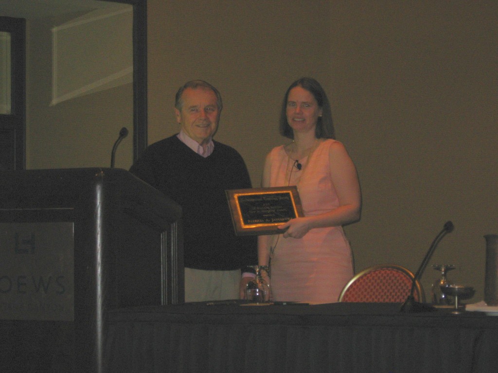 Dr. Richard Butcher presents Dr. Patricia Janulewicz with the award at the 2013 meeting.